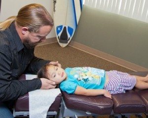 child receiving chiropractic adjustment