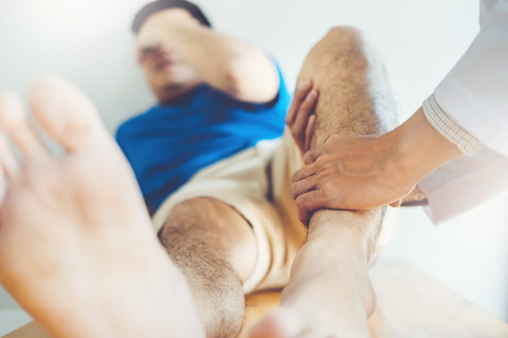 man with knee sports injury getting sports chiropractor treatment