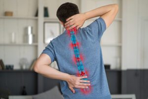 man with back pain needing sciatica treatment chiropractor